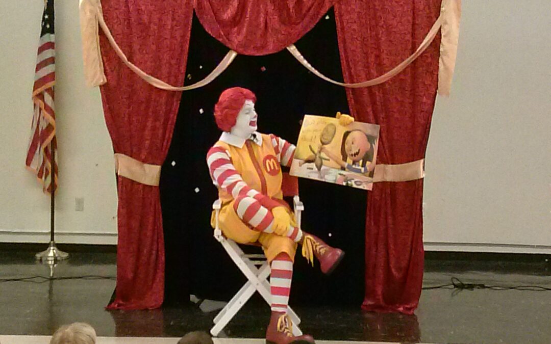 Ronald McDonald reads to children during ELC's Reading with Ronald Event.