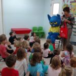 Pete the Cat and Joan Whitson, ELC of North Florida Early Literacy Outreach Manager, read books from the book bag project to hildren at Seaside School in St. Augustine.